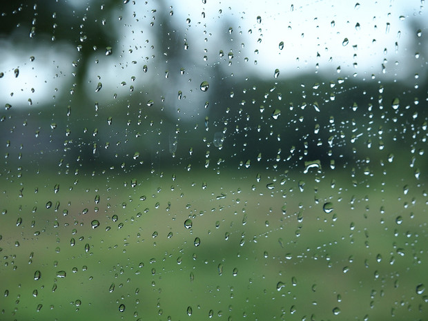 透过满是雨珠的玻璃一片模糊